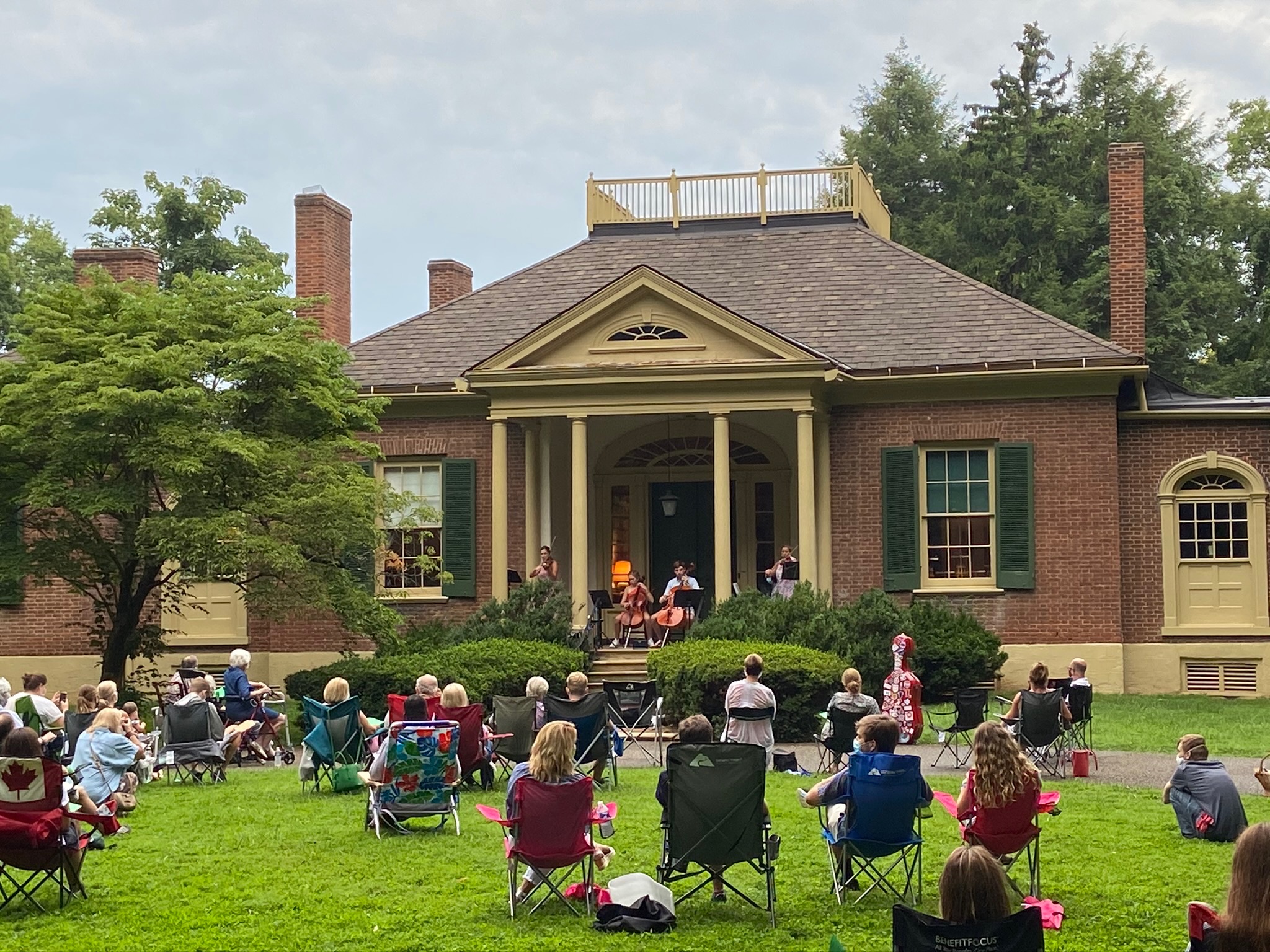 Guests enjoying a string ensemble on Ridgeway’s front portico